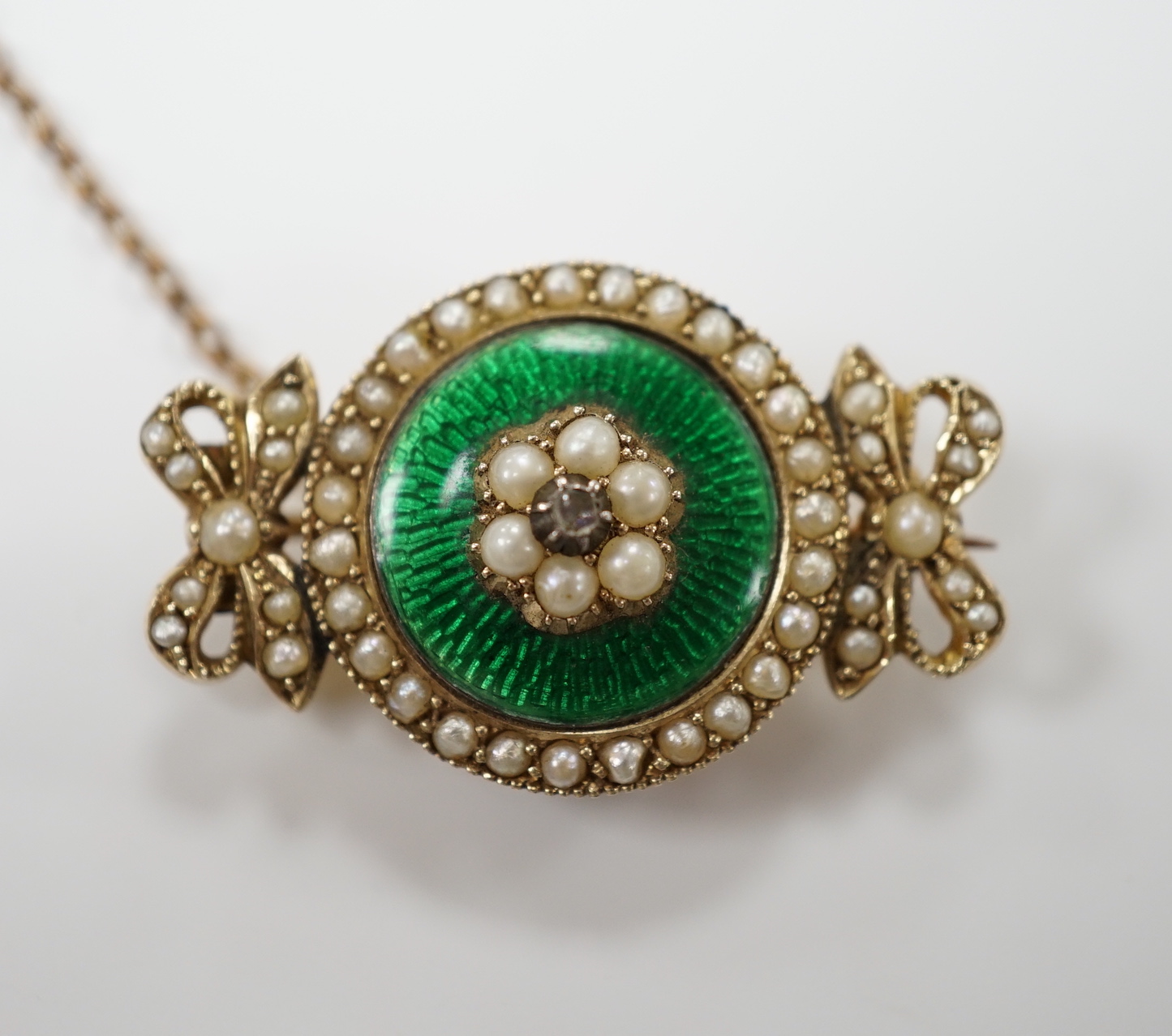 An early 20th century yellow metal, enamel, diamond and seed pearl set brooch, 30mm, gross weight 6.9 grams.